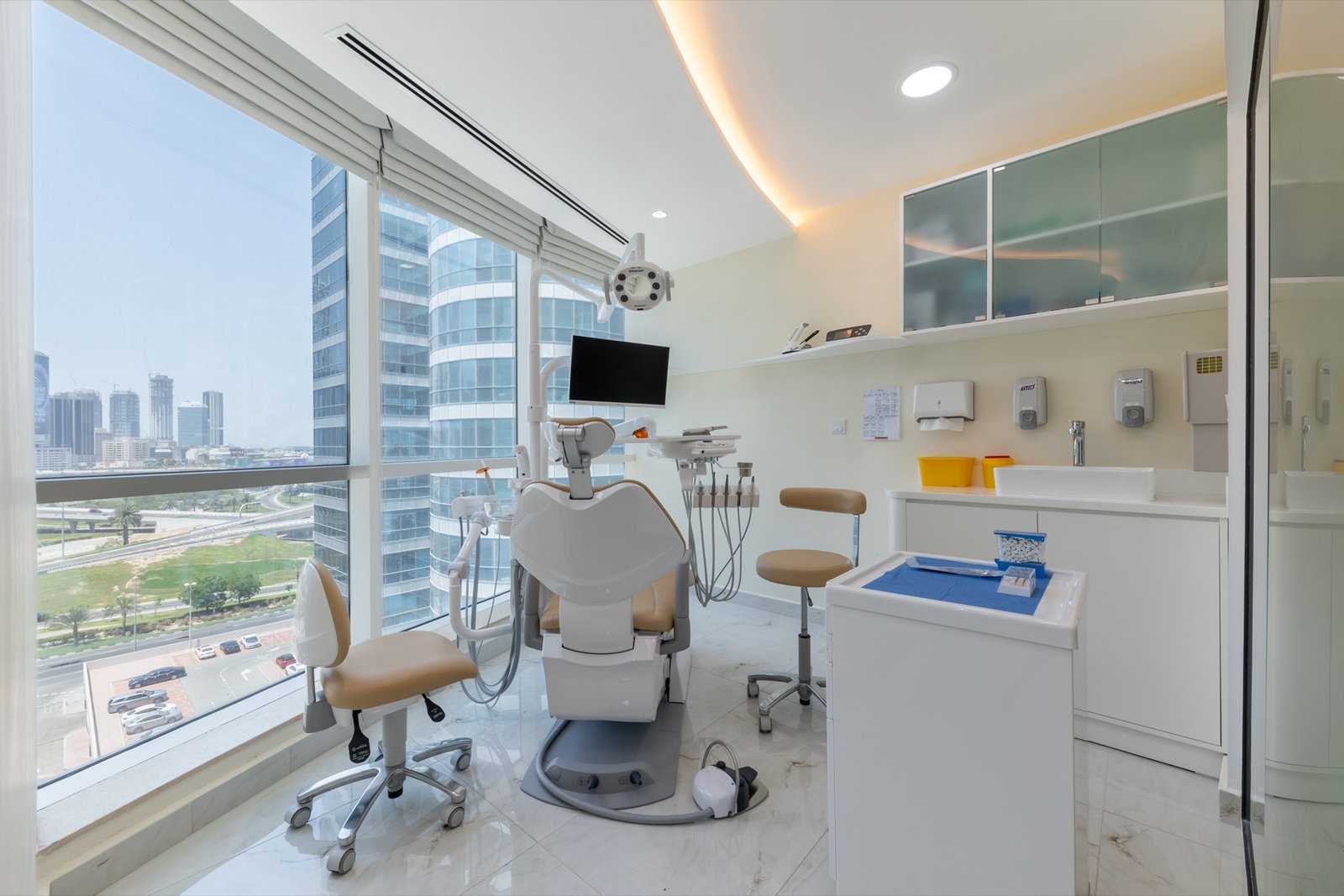 Treatment room at Digital Laser Dentistry with a panoramic view of the Jumeirah Lakes Towers skyline